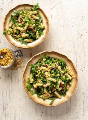 Two vintage bowls filled with pasta and greens